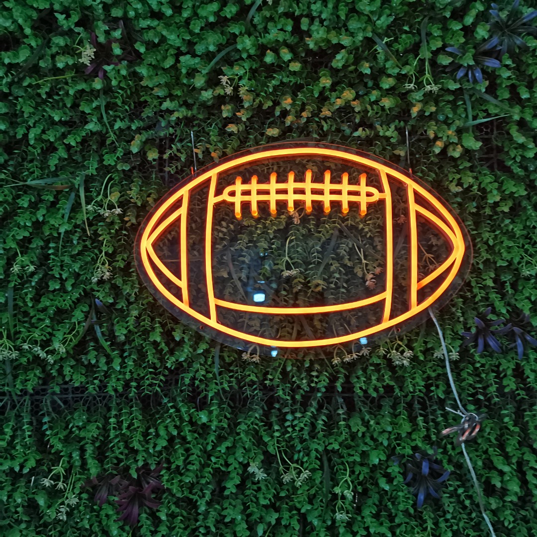 Rugby Football Neon Sign glowing on wall